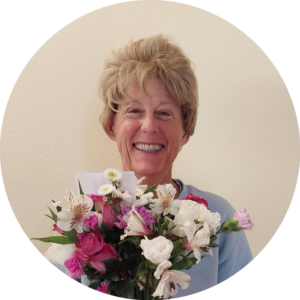 Jen Parks smiles holding a bouquet of flowers, by Michael Parks
